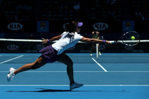 Na Li of China plays a forehand in her semifinal match against Maria Sharapova of Russia
