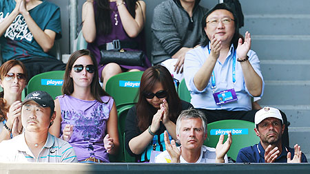 Li Na's husband Jiang Shan (left) and coach Carlos Rodriguez (right) watch her women's singles semi-final against Maria Sharapova on Thursday
