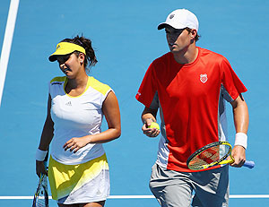 Sania Mirza of India and Bob Bryan of the United States of America talk tactics in their mixed doubles quarter-final on Thursday