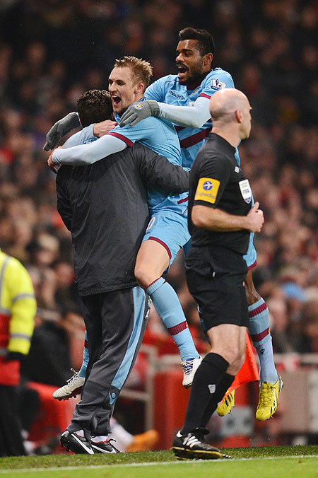Jack Collison of West Ham United celebrates with teammate Ricardo Vaz Te and team staff after scoring the opening goal