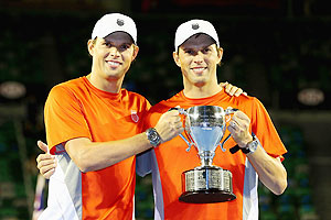Bob Bryan and Mike Bryan of the United States celebrate with the championship trophy after winning their doubles final against Robin Haase of the Netherlands and Igor Sijsling of the Netherlands at the Australian Open on Saturday
