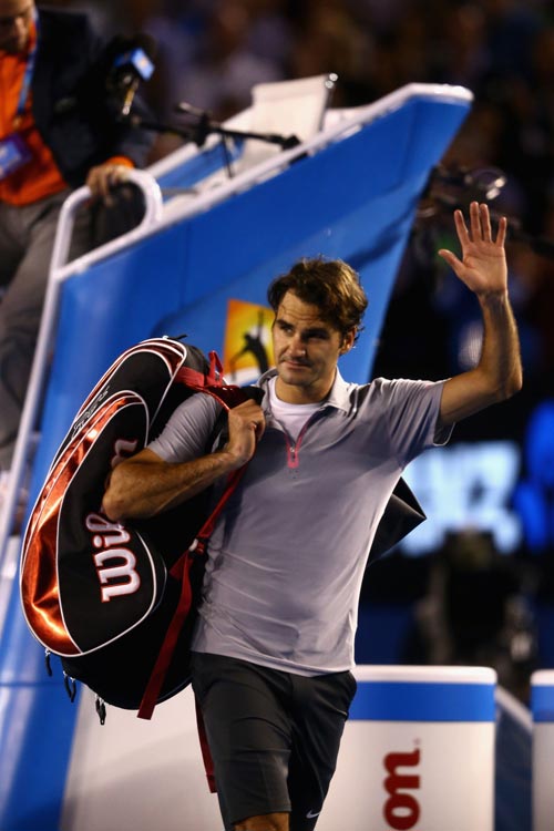 Roger Federer of Switzerland leaves the court after losing his semifinal match against Andy Murray