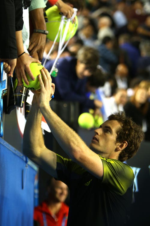 Andy Murray of Great Britain signs an autograph after winning his semifinal match against Roger Federer