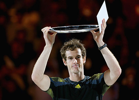 Andy Murray of Great Britain holds the runner up plate after losing the final against Novak Djokovic