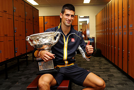 Novak Djokovic poses with the Norman Brookes Challenge Cup in the changerooms after winning his final against Andy Murray on Sunday