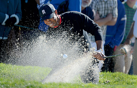 Tiger Woods hits out of the 11th green bunker en route to his -14 under victory during the Final Round at the Farmers Insurance Open at Torrey Pines Golf Course on Monday