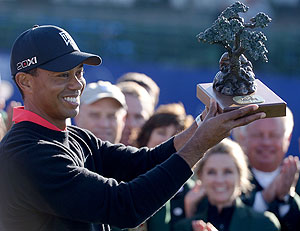 Tiger Woods holds the winner's trophy after winning his 75th PGA tour title at the Torrey Pines Golf Course in La Jolla, California on Monday
