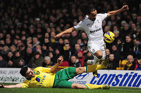 Benoit Assou Ekotto of Spurs is tackled by Robert Snodgrass of Norwich City during their match on Wednesday
