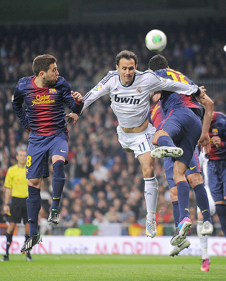Real Madrid's Ricardo Carvalho (right) goes for a high ball against Jordi Alba of Barcelona