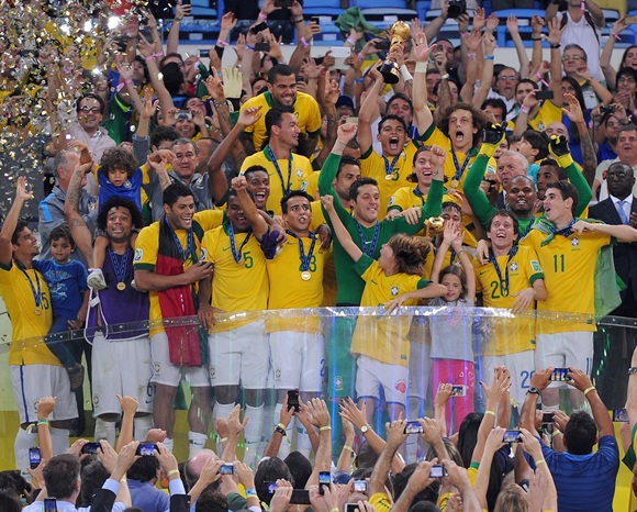 The Brazil players celebrate with the trophy