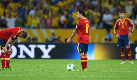 Xavi Hernandez of Spain prepares to kick off with teammate Fernando Torres (left) after conceding their third goal