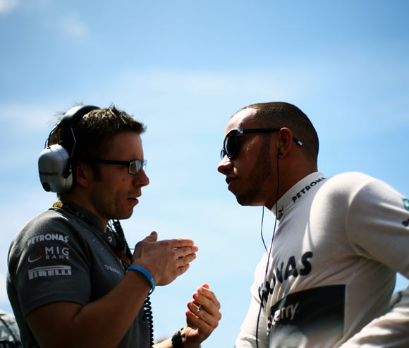 Lewis Hamilton (right) talks to his race engineer