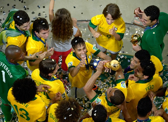 The Brazil players celebrate with the trophy