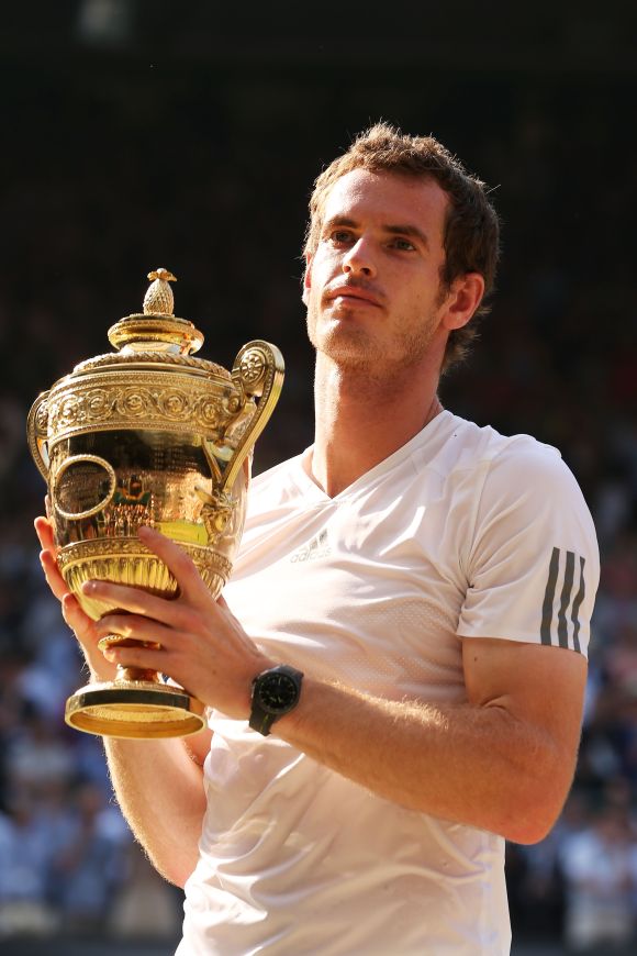 Andy Murray of Great Britain poses with the Gentlemen's Singles Trophy following his victory in the Gentlemen's Singles Final match against Novak Djokovic of Serbia on day thirteen of the Wimbledon Lawn Tennis Championships