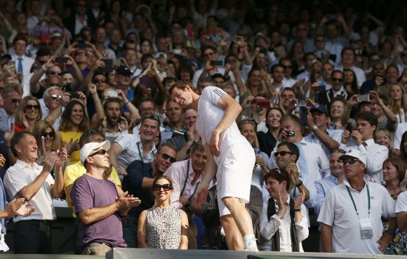 Andy Murray of Britain celebrates with friends and members of his team after defeating Novak Djokovic of Serbia in their men's singles final tennis match at the Wimbledon Tennis Championships