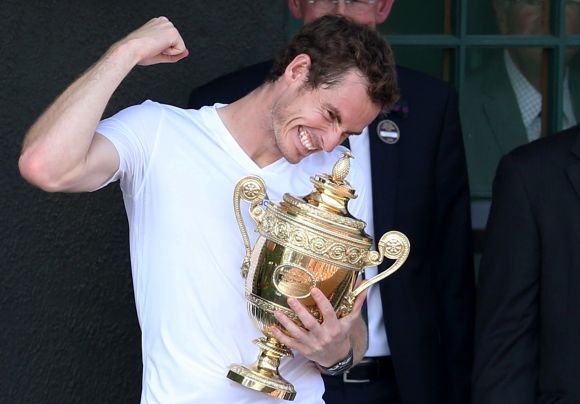 Andy Murray of Britain holds the winners trophy on the clubhouse balcony after defeating Novak Djokovic of Serbia in their men's singles final tennis match at the Wimbledon Tennis Championships