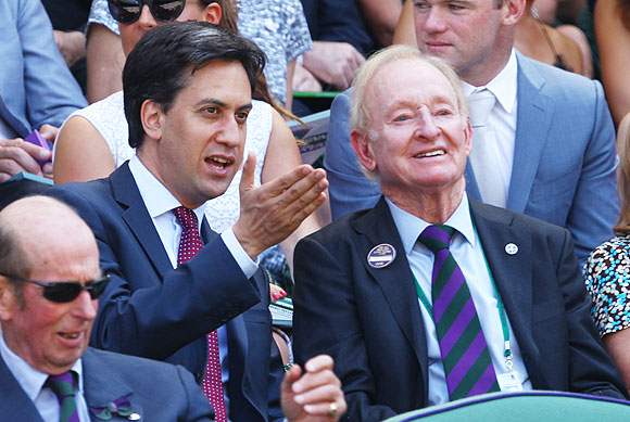 Leader of the Labour Party Ed Miliband speaks with legendary tennis star Rod Laver before the Wimbledon men's final between Andy Murray and Novak Djokovic on Sunday