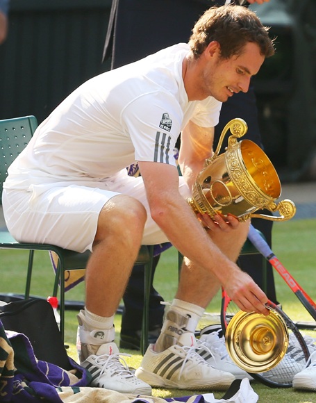 Andy Murray of Great Britain drops the lid of the Gentlemen's Singles Trophy