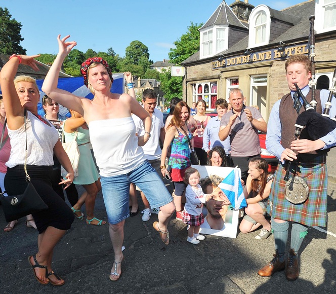 Dunblane residents take to the streets to celebrate after watching local boy Andy Murray of Great Britain beat Novak Djokovic
