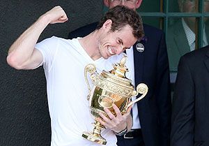 Andy Murray of Britain holds the winners trophy on the clubhouse balcony after defeating Novak Djokovic of Serbia to win the Wimbledon crown on Sunday