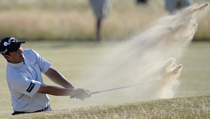 Shiv Kapur of India chips onto the tenth green during the first round of the British Open golf championship at Muirfield