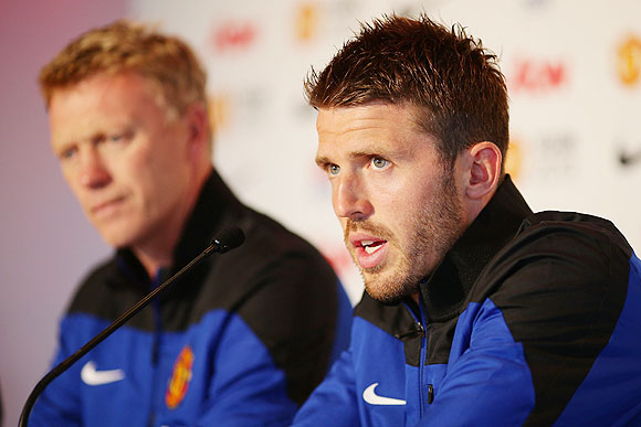 Michael Carrick (right) speaks to the media as Manchester United manager David Moyes looks on during a Manchester United press conference at Museum of Contemporary Art on in Sydney, Australia, on Friday