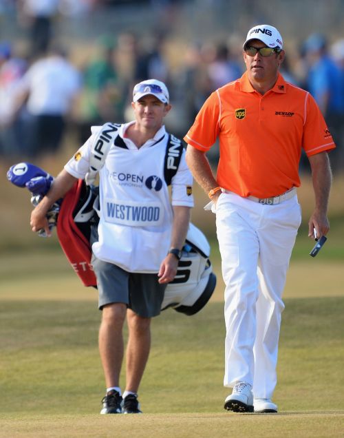 Lee Westwood of England walks up the 18th fairway with his caddie Michael Kerr 