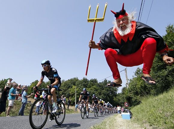 In this file photo, Didi Senft, a cycling enthusiast better known as 'El Diablo' (The Devil), jumps as the pack of riders cycles during the twelfth 218km stage of the centenary Tour de France cycling race from Fougeres to Tours