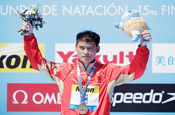 Gold medallist Li Shixin of China celebrates after winning the Men's 1m Springboard Diving final on day three of the 15th FINA World Championships at Piscina Municipal de Montjuic in Barcelona on Monday