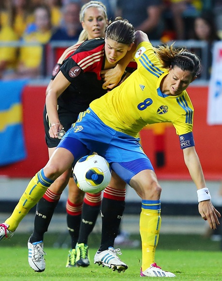 Lotta Schelin (8) of Sweden and Annike Krahn (back) of Germany battle for the ball during the UEFA Women's Euro 2013 semi final match