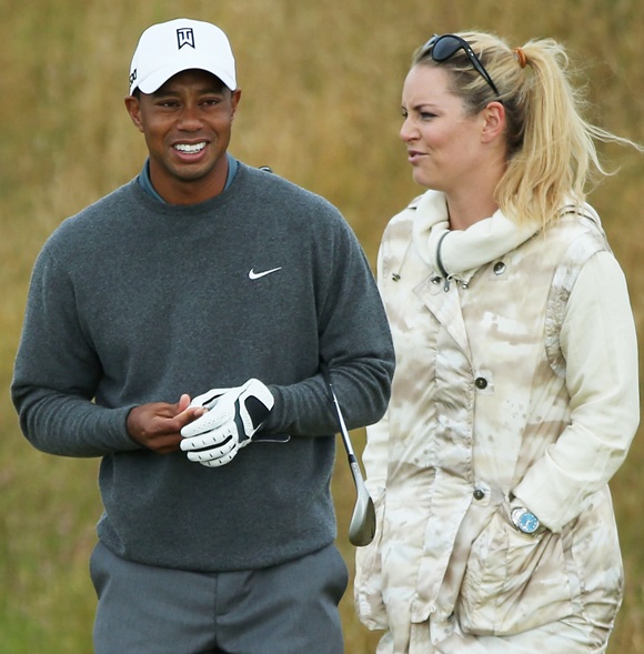 Tiger Woods of the United States smiles alongside skier Lindsey Vonn