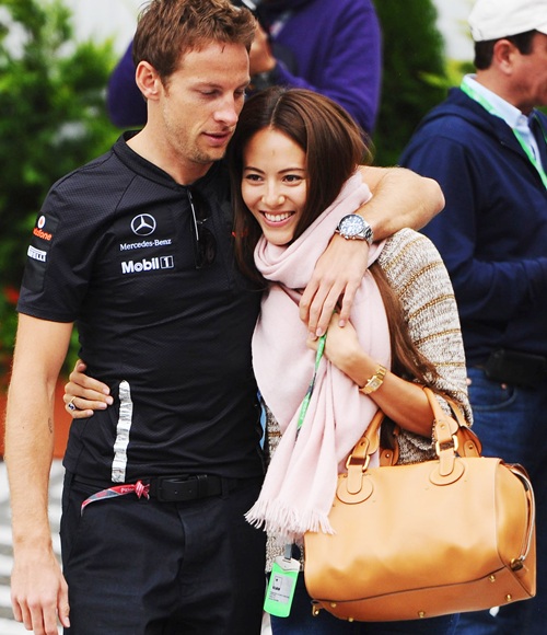 Jenson Button of Great Britain and McLaren and his girlfriend Jessica Michibata