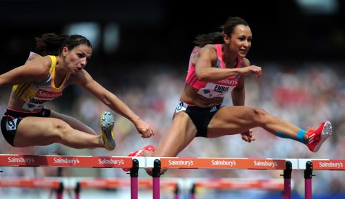 Nadine Hildebrand of Germany and Jessica Ennis-Hill of Great Britain compete in the Women's 100m Hurdles during day two of the Sainsbury's Anniversary Games - IAAF Diamond League 2013 at The Queen Elizabeth Olympic Park