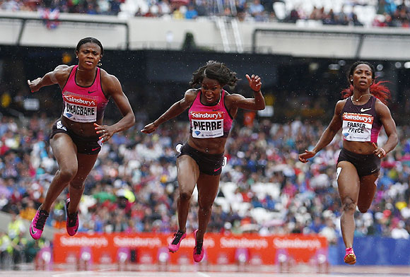 Blessing Okagbare of Nigeria (left) wins the women's 100m, with Barbara Pierre of the U.S. (centre) second and Shelly-Ann Fraser-Pryce of Jamaice (right) fourth, at the London Diamond League 'Anniversary Games' athletics meeting at the Olympic Stadium, in London on Saturday