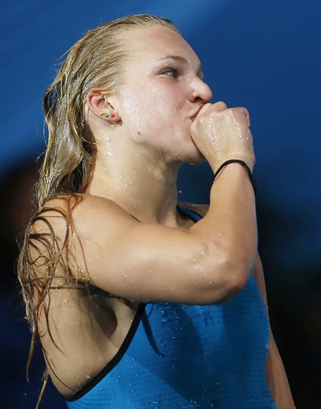 Lithuania's Ruta Meilutyte gestures after winning the women's 100m breaststroke semi-final with a new world record