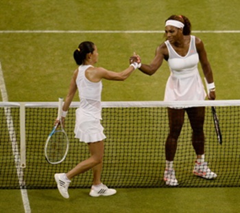 Serena Williams (R) shakes hands at the net with Kimiko Date-Krumm after their match