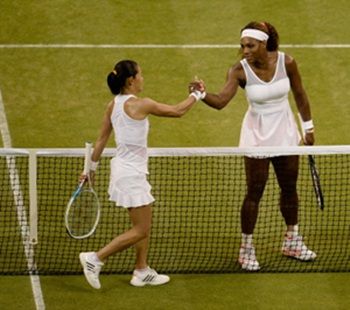 Serena Williams (R) shakes hands at the net with Kimiko Date-Krumm after their match
