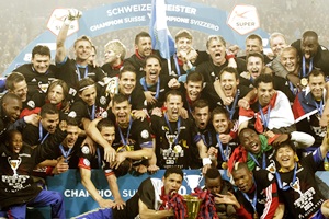The FC Basel team poses with the trophy after winning the Swiss soccer championship