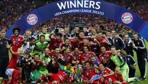 Bayern Munich players and staff celebrate with the trophy after winning the Champions League final