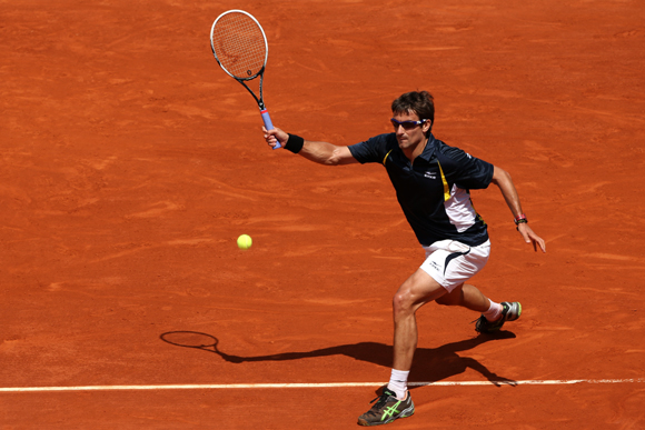 Tommy Robredo of Spain plays a forehand during his match against compatriot Nicolas Almargo