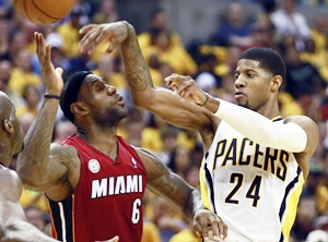 Indiana Pacers' Paul George (right) passes over Miami Heat's LeBron James