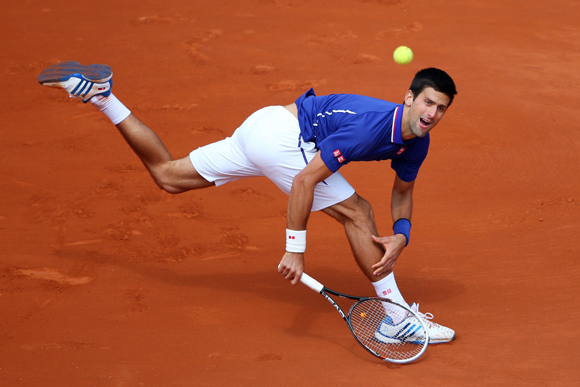 Novak Djokovic of Serbia plays a backhand during his match against Philipp Kohlschreiber of Germany