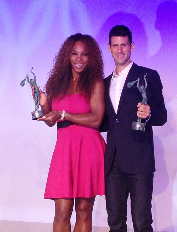 Serena Williams and Novak Djokovic show off their trophies at the ITF Champions Dinner on Tuesday