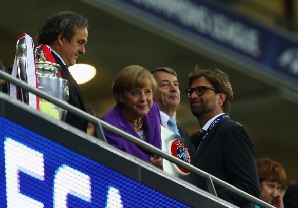 UEFA President Michel Platini, German Chancellor Angela Merkel and President of the German Football Association Wolfgang Niersbach offer their commiserations to Borussia Dortmund Head Coach Jurgen Klopp