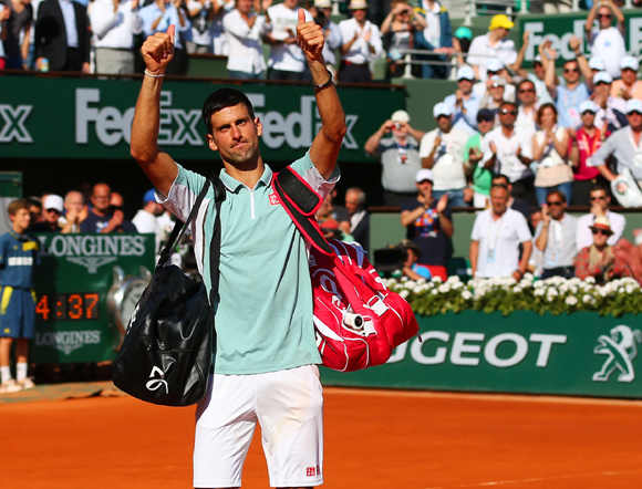 Novak Djokovic of Serbia applauds the fans as he walks off court after losing to Rafa Nadal
