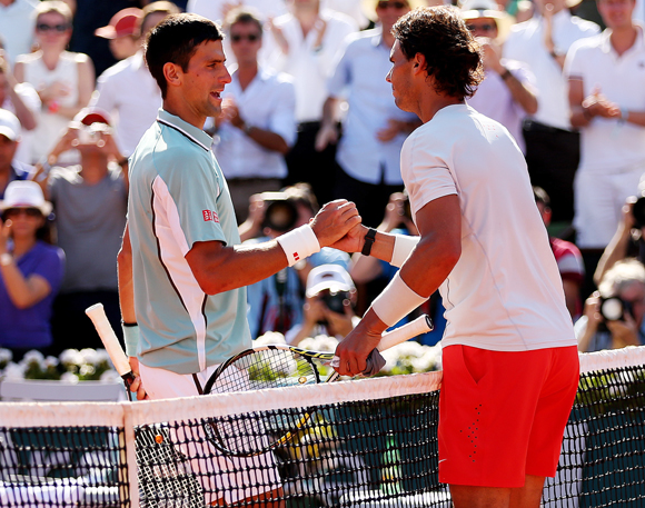 Rafael Nadal of Spain shakes hands at the net with Novak Djokovic of Serbia after their semi-final