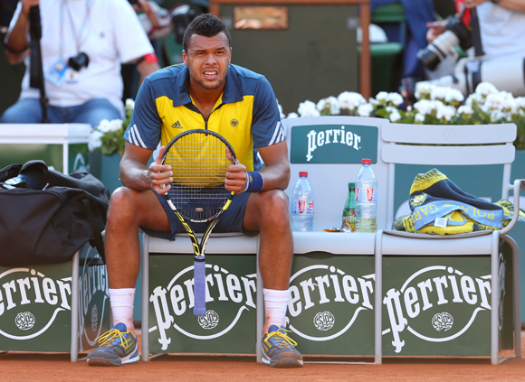 Jo-Wilfried Tsonga of France looks on as he takes a break during the semi-final against David Ferrer of Spain