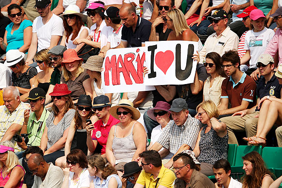 Tennis fans hold a banner in support of Maria Sharapova during the French Open final