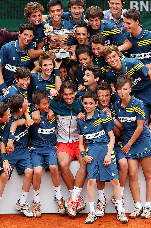 Rafael Nadal of Spain poses with the ballboys, ballgirls as he celebrates his French Open victory on Sunday
