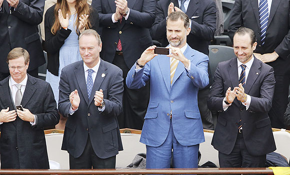 Spain's Crown Prince Felipe (2nd from right) takes a photograph during the men's singles final match between Rafael Nadal of Spain and compatriot David Ferrer on Sunday